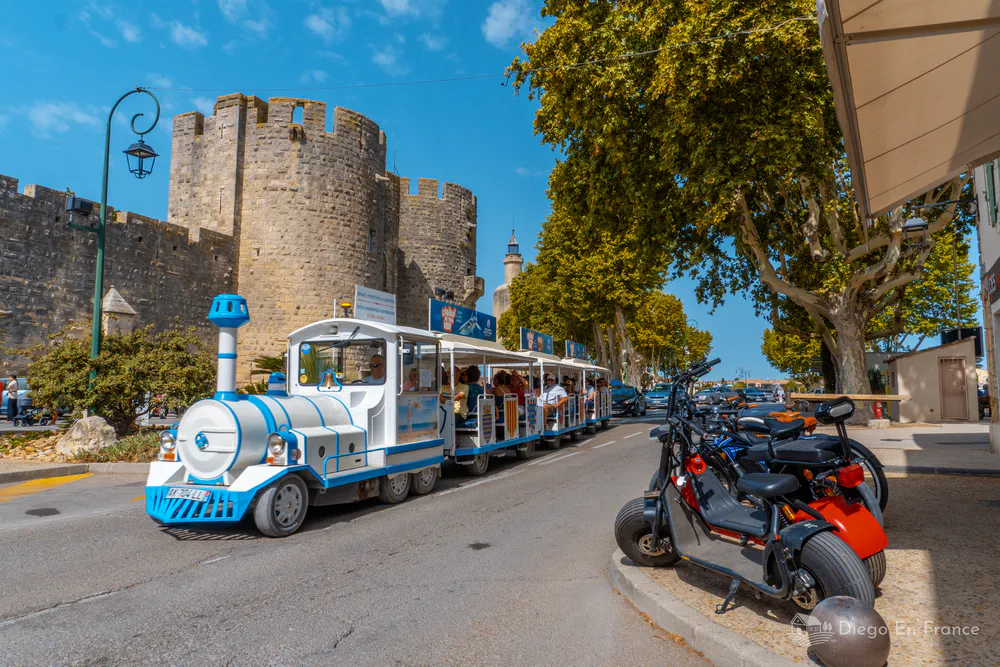 Tren touristique devant les remparts d’Aigues-Mortes, idéal à parcourir avec des enfants. Photographie de diegoenfrance.com