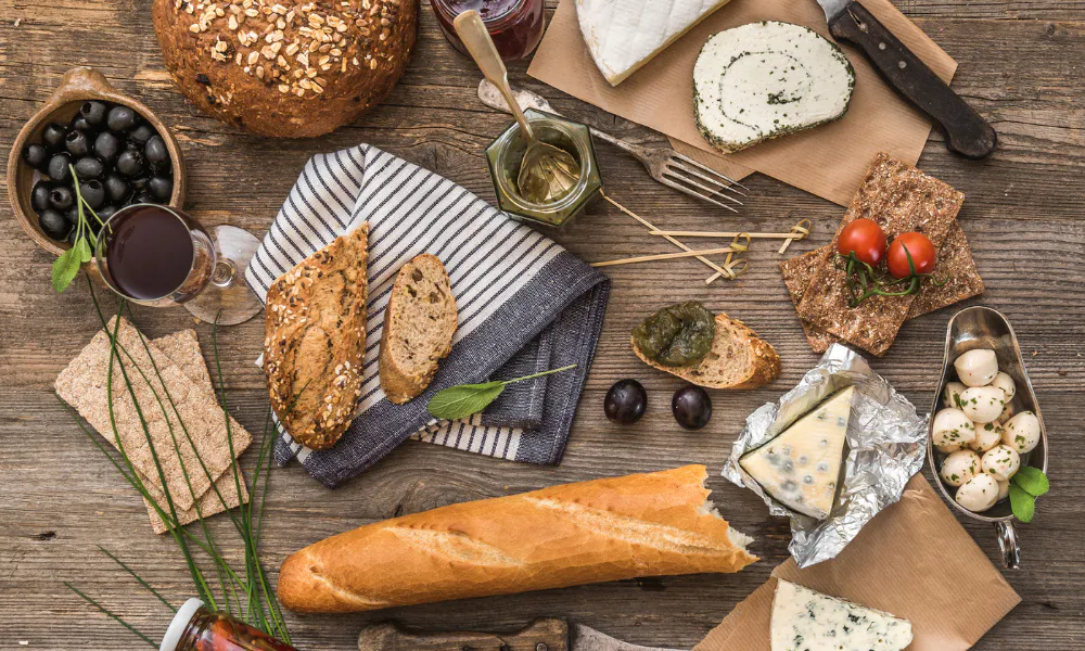Table set with regional specialties such as cured meats, cheeses and wines to discover the authentic flavors on a food tour in Toulouse.