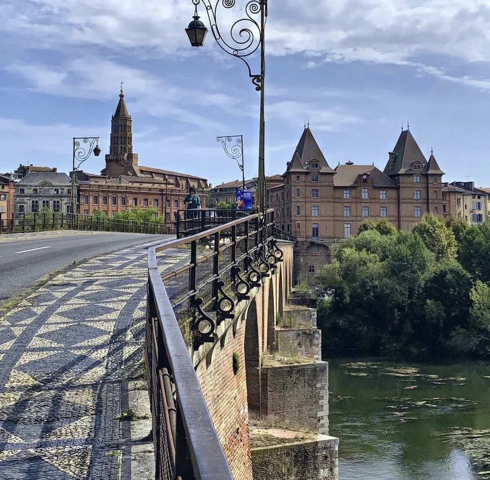 View of the Old Bridge of Montauban with the historic center in the background, perfect for an excursion from Toulouse.