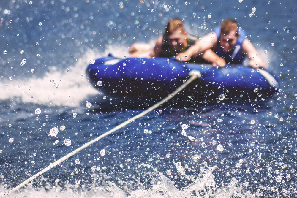 Children on a float being towed at Original Green Park, a water sports park near Saint-Sulpice-la-Pointe.