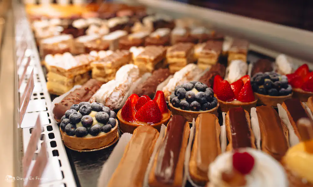 Display case of eclairs, tartlets and cakes in a local bakery near Saint-Sulpice-la-Pointe.