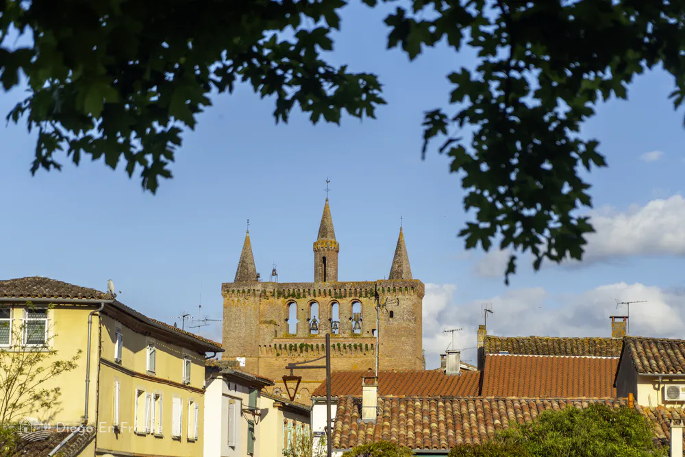 Tower of the Église Saint-Sulpice seen from the village, standing out against the urban landscape.