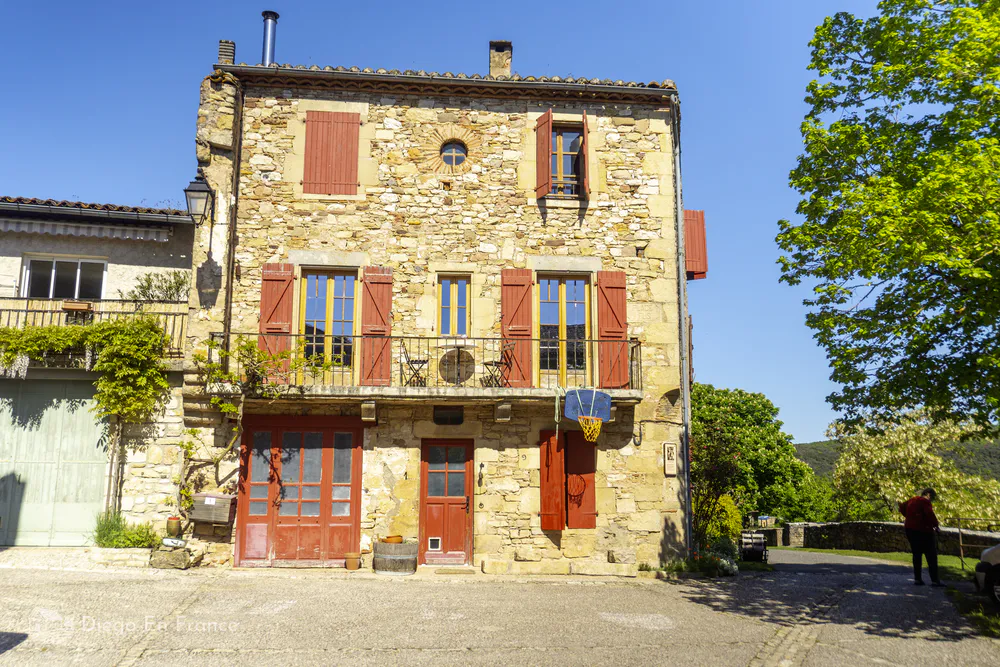 Old town of Puycelsi with medieval charm and spring floral details.