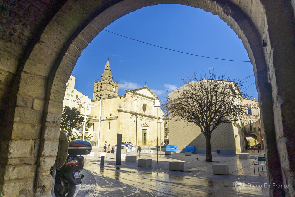 Entrée encadrée par une arche de pierre donnant sur l'église Notre-Dame-du-Lac à Lunel. Photo par diegoenfrance.com