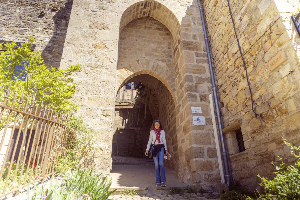 Stone archway entrance leading to the fortified village center of Bruniquel in southern France.